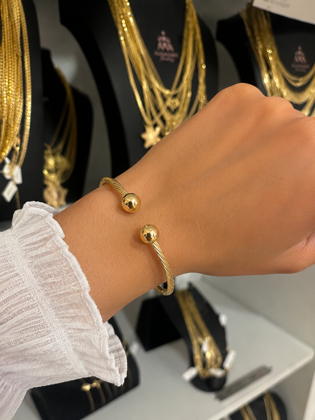 Crafted from genuine 10K gold, this elegant cuff bracelet features a sophisticated twisted design with polished ball ends for a timeless and modern look. Its versatile style makes it perfect for everyday wear or special occasions. Made with real 10K gold